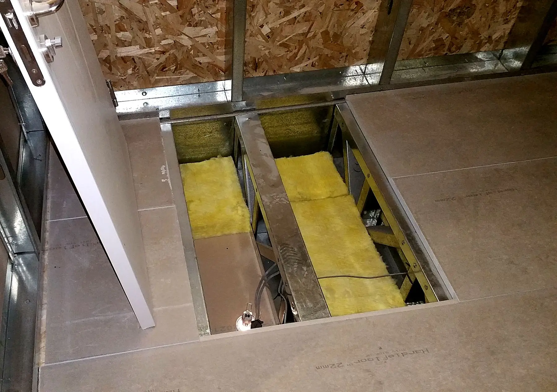 Light gauge steel floor joists with mineral wool insulation between them