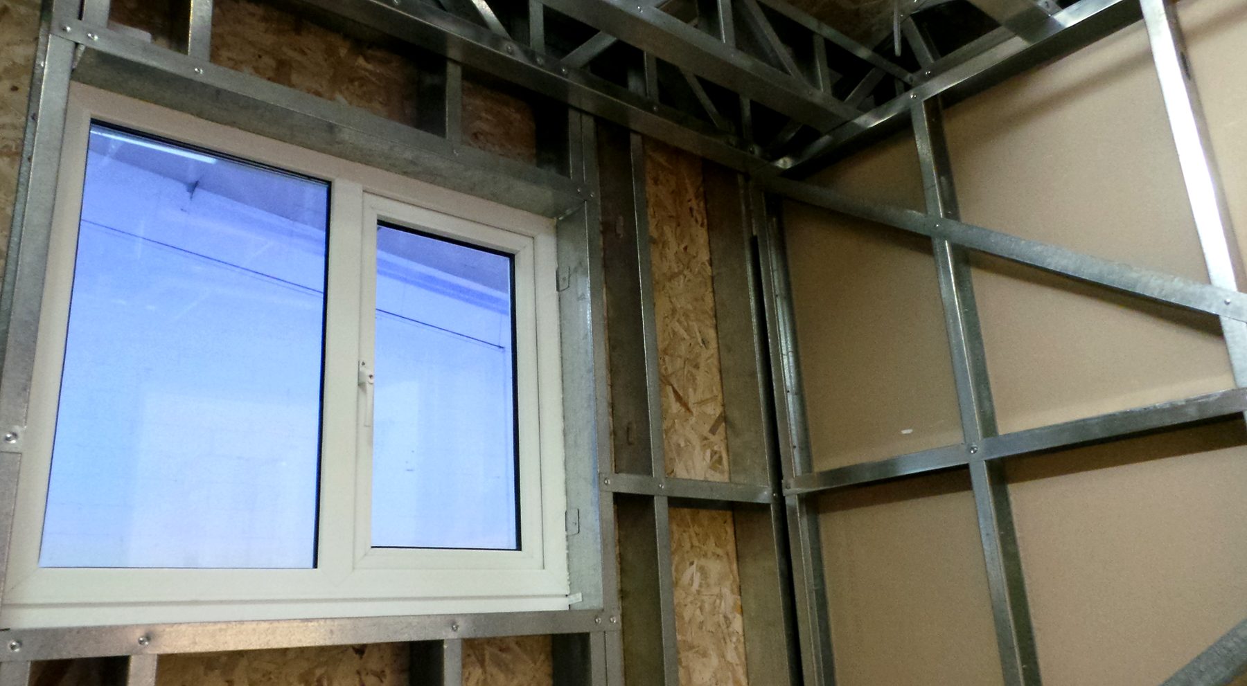 Light gauge steel stud framing around a fitted window