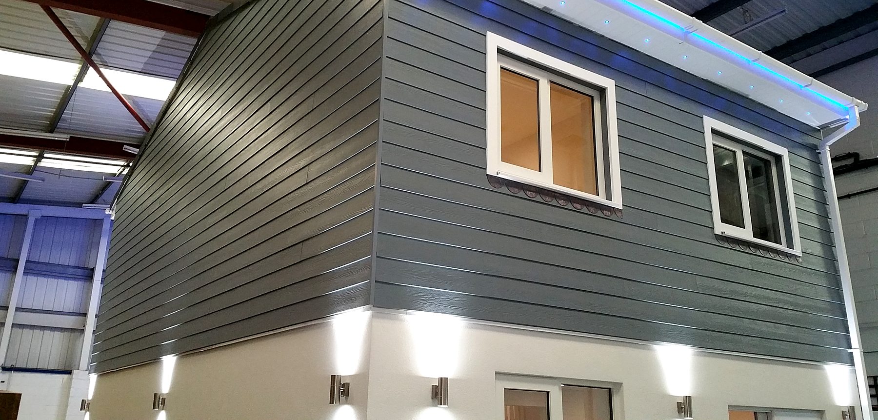 Grey board cladding and windows on the upper storey of the showhouse